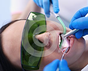 Dental team and patient at dentist`s surgery