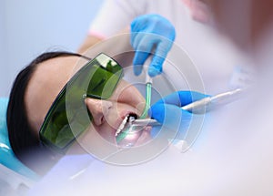 Dental team and patient at dentist`s surgery