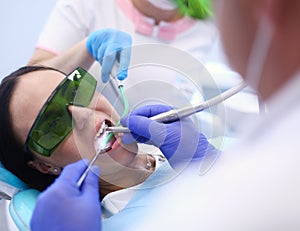 Dental team and patient at dentist`s surgery