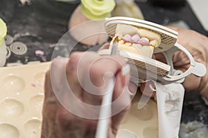 Dental Technician Applying Porcelain To 3D Printed Implant Mold