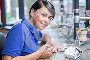 Dental technician applying wax to a mold to produce a prothesis