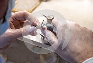 Dental technician crafting tooth crowns by hand