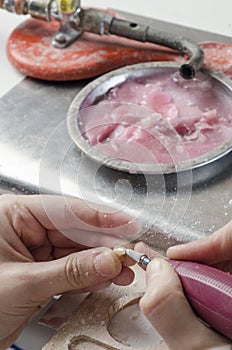 Dental technician doing partial dentures of acrylic resins.