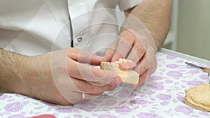 Dental technician examining gypsum plaster cast of jaws and removable dentures