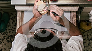 Dental technician fixing the parts of a dental prosthetic