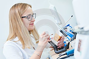 Dental technician or prosthesis worker. prosthetic dentistry process photo