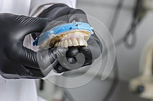 Dental technician holding a monolithic zirconia photo