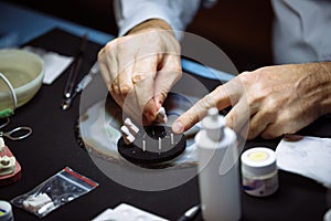Dental technician makes dentures.
