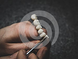 A dental technician makes a prosthetic teeth. laboratory. close-up.