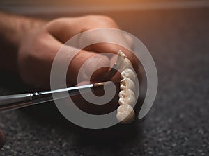 A dental technician makes a prosthetic teeth. laboratory. close-up.