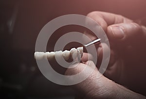 A dental technician makes a prosthetic teeth. laboratory. close-up.