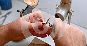 dental technician polishes metal dentures in his workshop