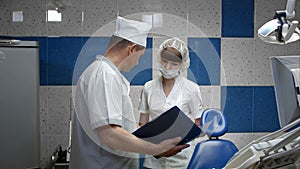 Dental technician talking with doctor in a lab