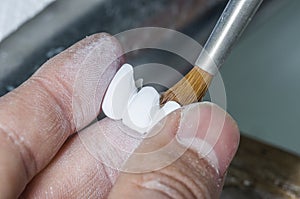 dental technician using dental burs with zirconium teeth. photo