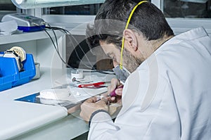 dental technician using dental burs with zirconium teeth.