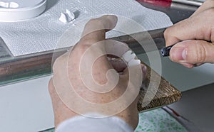 dental technician using dental burs with zirconium teeth. photo