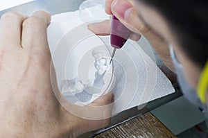 dental technician using dental burs with zirconium teeth. photo