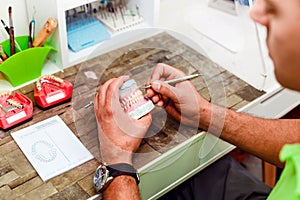 Dental technician working with artificial implants