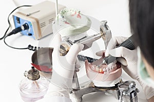Dental technician working with articulator