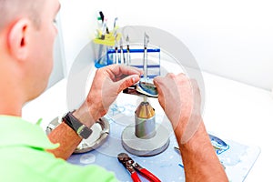 Dental technician working with artificial implants