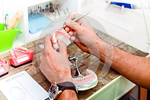 Dental technician working with artificial implants