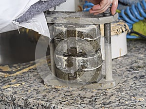 Dental technician is working with a dental flask of a complete u