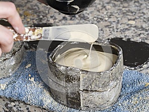 Dental technician is working with a dental flask of a complete u