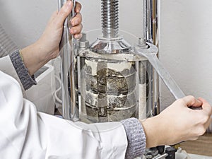 Dental technician is working with a dental flask of a complete u