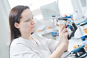Dental technician or female prosthesis worker. prosthetic dentistry process photo