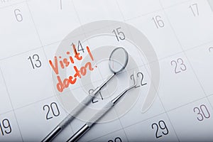 Dental tools on calendar with mark. Dental care concept