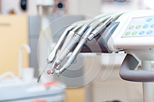 Dental tools on dentist chair with medical equipment