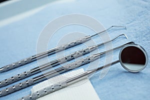 Dental Tools and Gauze on a Paper Lined Tray