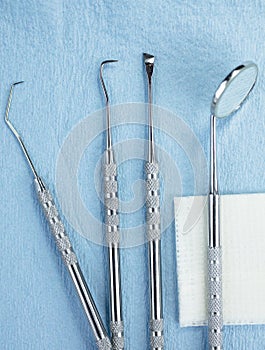 Dental Tools and Gauze on a Paper Lined Tray