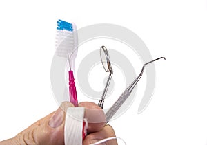 Dental tools with toothbrush interdental pick and floss.