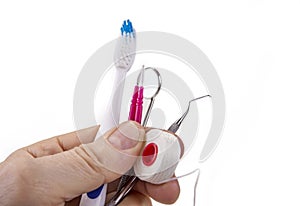 Dental tools with toothbrush interdental pick and floss.