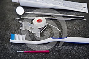 Dental tools with toothbrush interdental pick and floss.