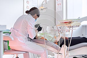 Dental treatment at the dental clinic, female doctor treating patient