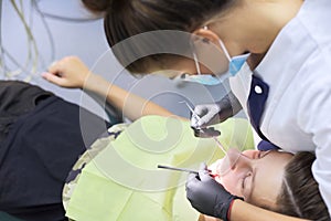 Dental treatment at the dental clinic, female doctor treating patient