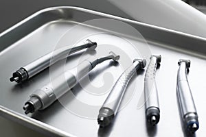 Dental turbine handpieces on metal tray closeup