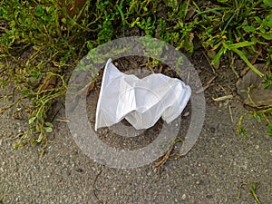 dented and discarded white disposable plastic cup