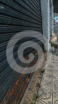 Dented and rusty steel commercial door photo