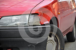 Dented and scratched red car photo