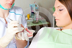 Dentis showing teeth prosthesis for woman patient