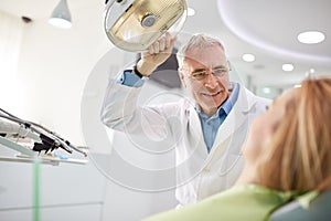 Dentist adjust searchlight before starting work