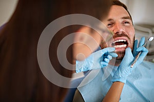 Dentist in ambulant looking patient`s teeth