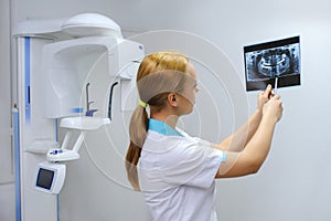 Dentist analyzes a dental panoramic x-ray film