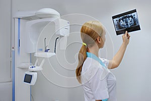 Dentist analyzes a dental panoramic x-ray film