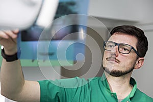 Dentist analyzing x-ray of teeth