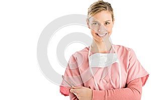 Dentist With Angled Mirror And Probe Standing Arms Crossed