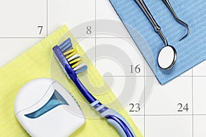 Dentist appointment date on calendar with toothbrush floss and tools dental appointment concept